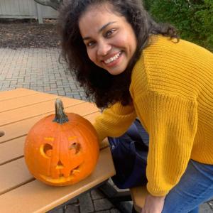 Tridaya Karuturi with carved pumpkin